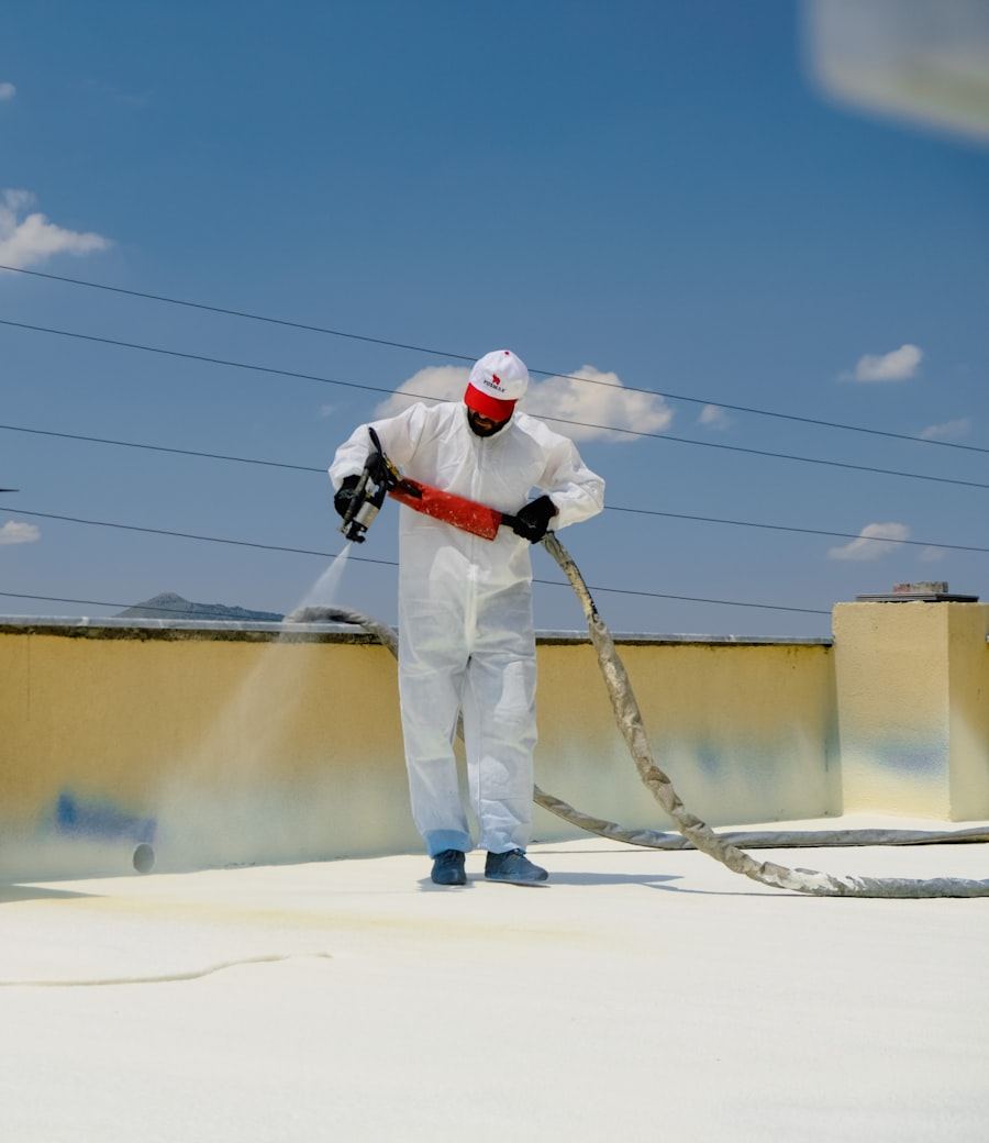 Waterproof coating being spray-applied on a rooftop by Doon Earth Solutions